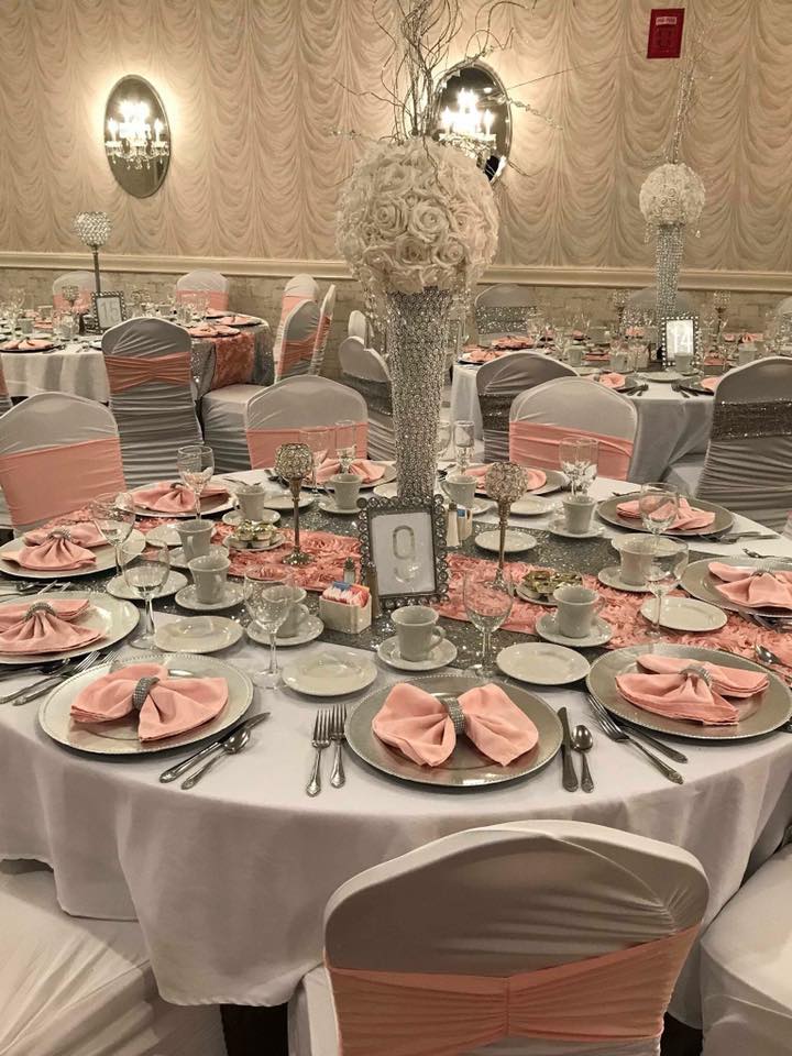 Bridal shower reception with tall white and blush rose ball centerpieces and peach satin napkins